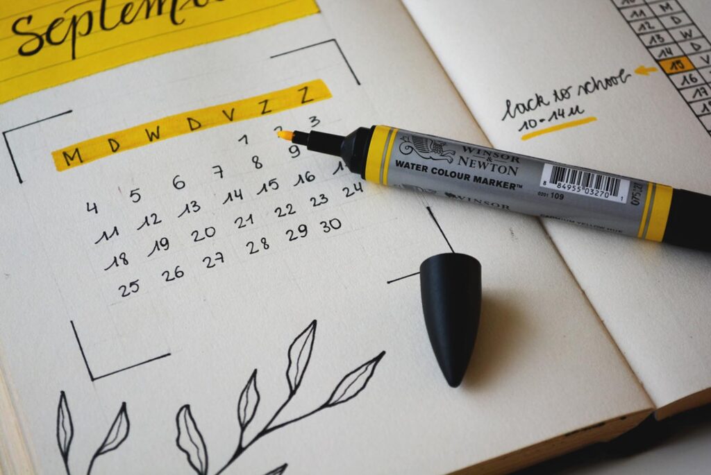 calendar in notebook with yellow highlighter