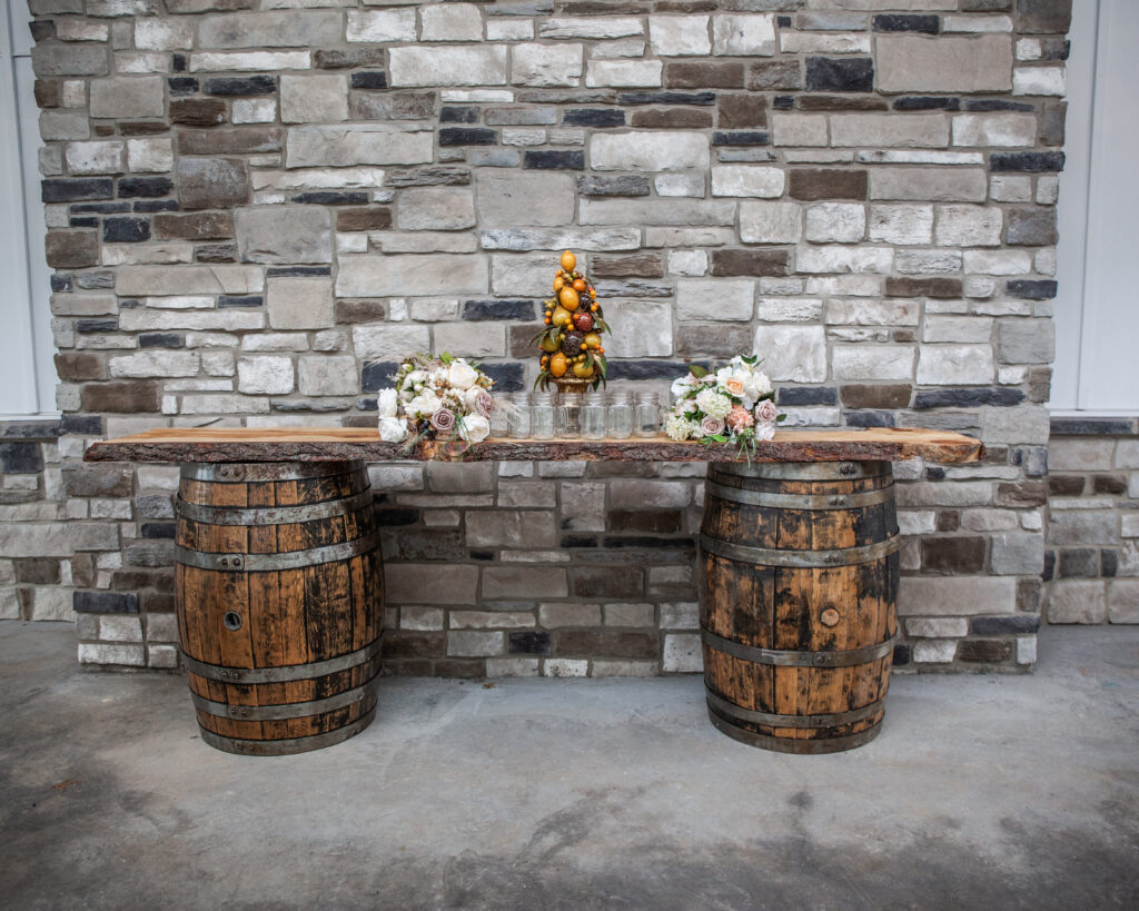 rustic barrel table with two flower bouquets