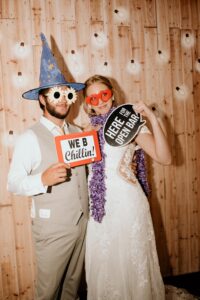 bride and groom posing with funny props
