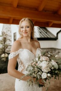 bride holding bouquet and smiling serenely