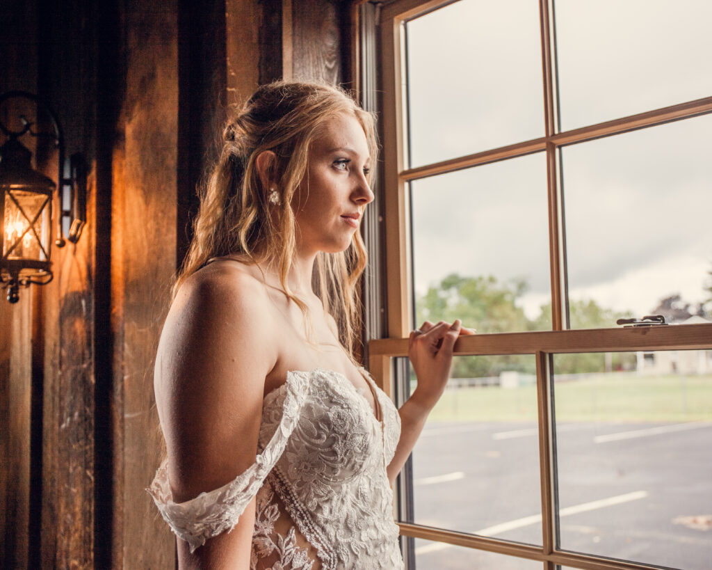 bride looking out venue bouchon window